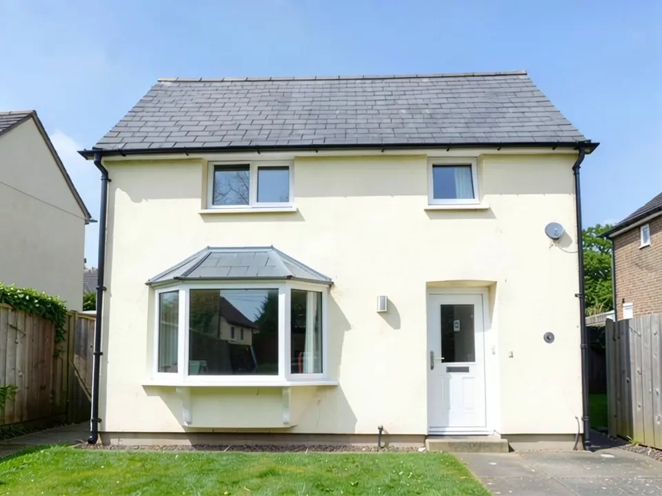 The same house where the flat window is now a three-sided bay window with white frames, a small grey roof on top and brackets underneath