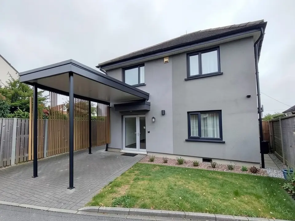 The same house with a long flat dark roof fixed to the front wall above the door canopy, slim black posts along the paved drive, and a vertical timber slat screen between the posts on the fence side